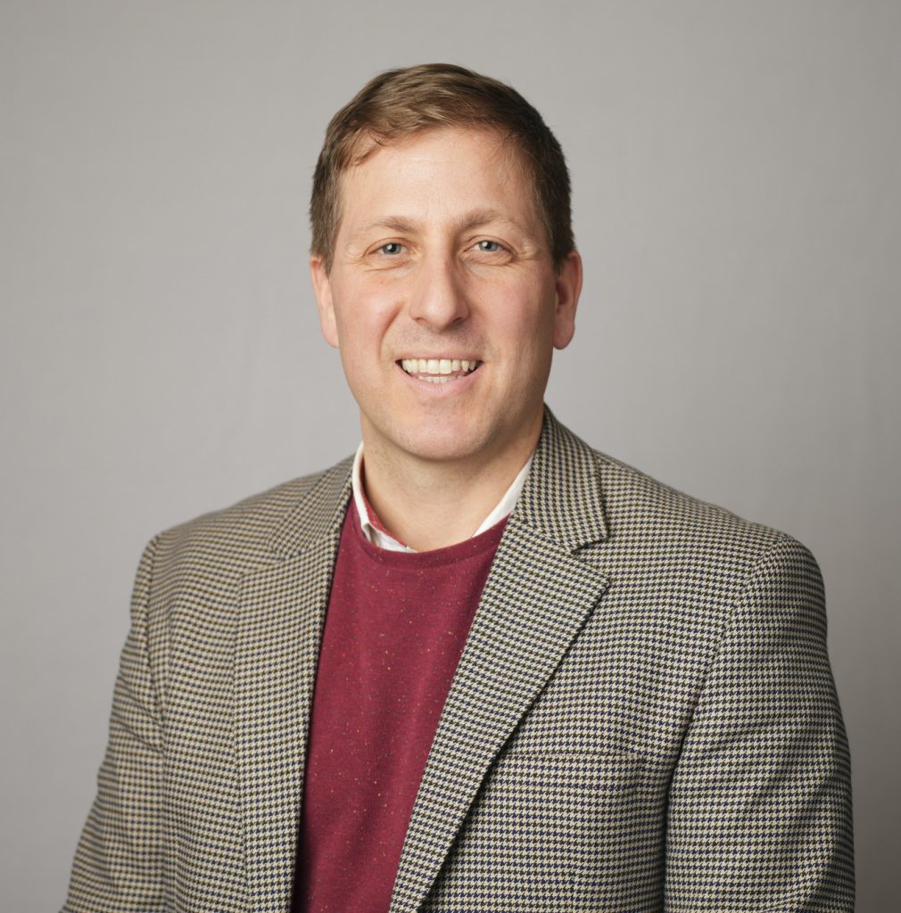 Alt Text: Photo of Thomas J. Balcerski wearing a suit and sweater.