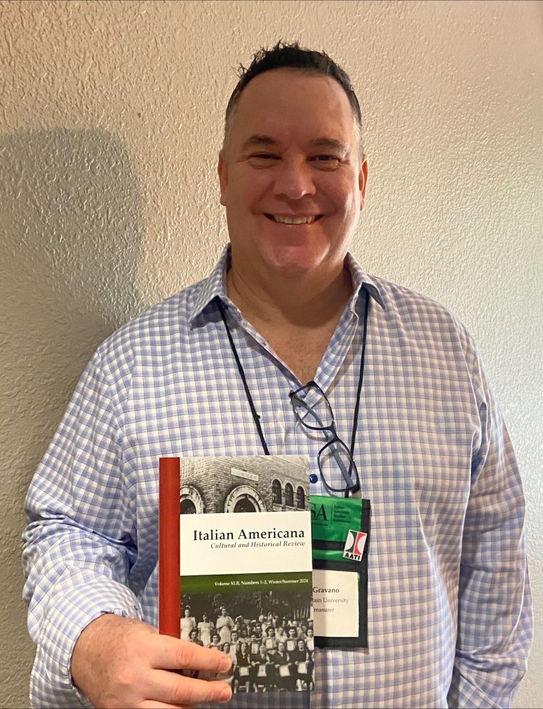 Editor Alan J. Gravano holding a copy of Italian Americana at the Italian American Studies Association Annual Conference in 2024.