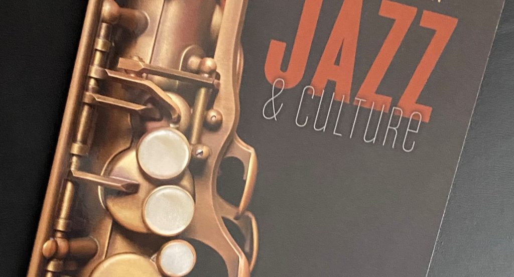 Close up cropped cover of Jazz & Culture with image of a saxophone on a black background.