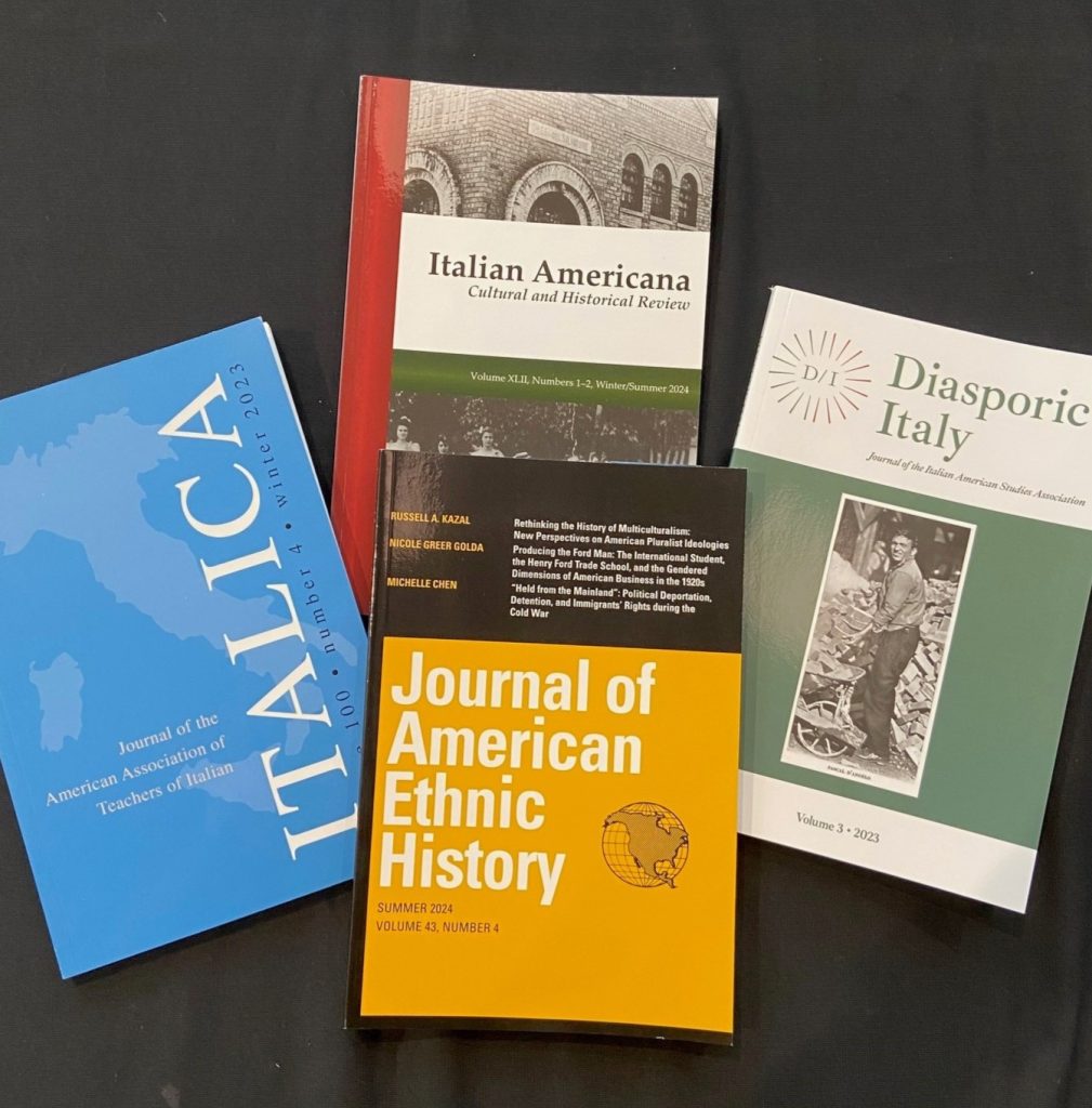 Issues of four journals laying on a black background: Italian Americana, Diasporic Italy, Journal of American and Ethnic History, and Italica