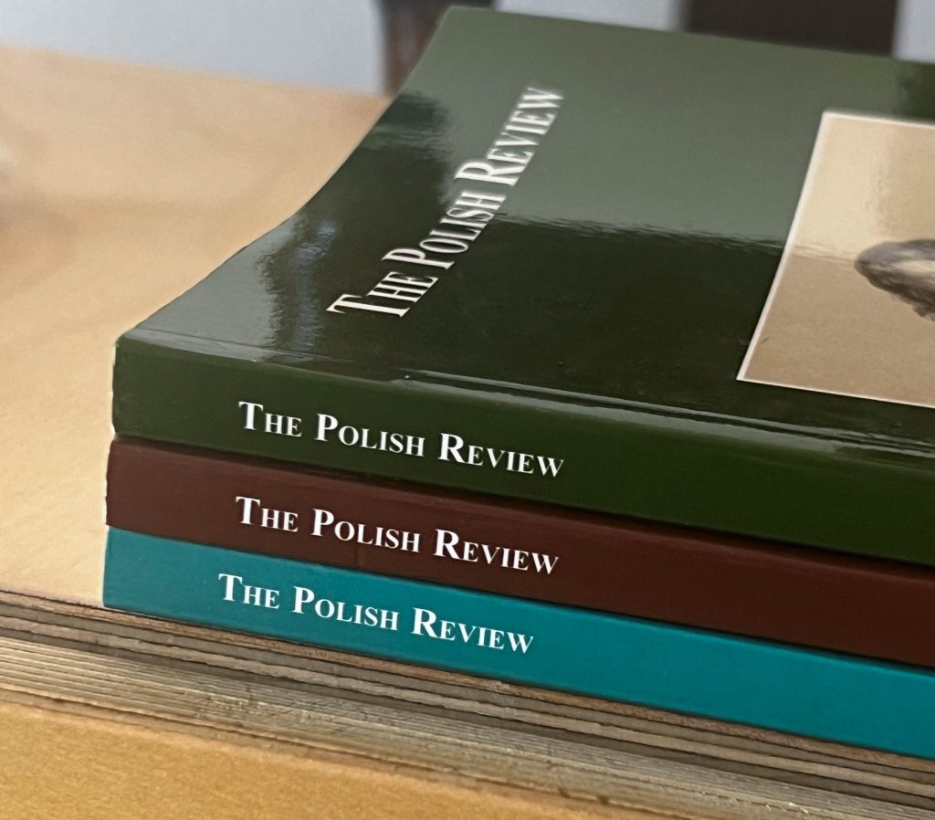 The spines of three issues of The Polish Review stacked on a table